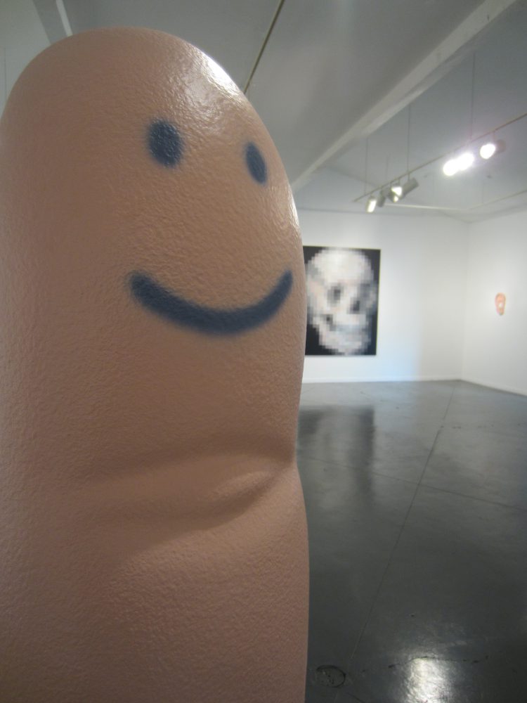 Rachel Hecker, Finger Statue, 2013, coated EPS foam and acrylic, 65 x 17 x 15 inches with Pixel Skull, 2010, acrylic on canvas, 78 x 60 inches
